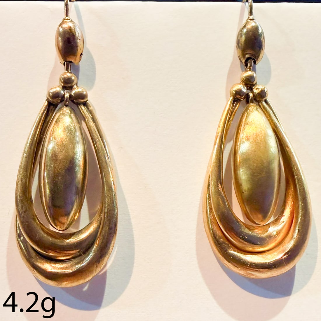 PAIR OF VICTORIAN DROP HOOP EARRINGS: PAIR OF VICTORIAN DROP HOOP EARRINGS,4,2 grams, testing high carat gold.Part entwinded design.Articulated centre.L. 4.5 cm.