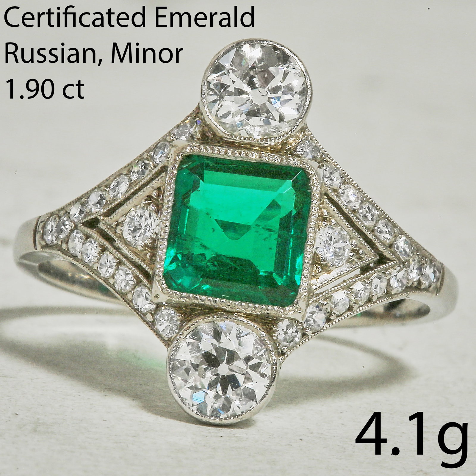 FINE ART DECO CERTIFICATED EMERALD AND DIAMOND RING: FINE ART DECO CERTIFICATED EMERALD AND DIAMOND RING4.1 grams, 18 ct gold. Fine emerald of deep colour (certificated Russian, minor enhancement) of approx. 1.90 ct.Bright and lively diamonds.Size Q 1/2
