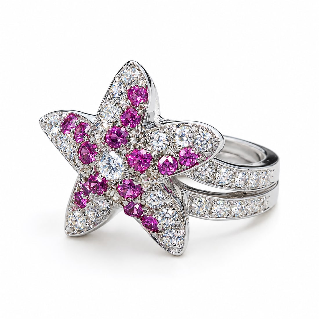 KUTCHINSKY, DIAMOND AND PINK SAPPHIRE SEA STAR RING: KUTCHINSKY, DIAMOND AND PINK SAPPHIRE SEA STAR RING,9.6 grams, 18 ct. gold.The Sea star set with bright and lively diamonds and rich and vibrant pink sapphires.With further diamond set shoulders.Signe