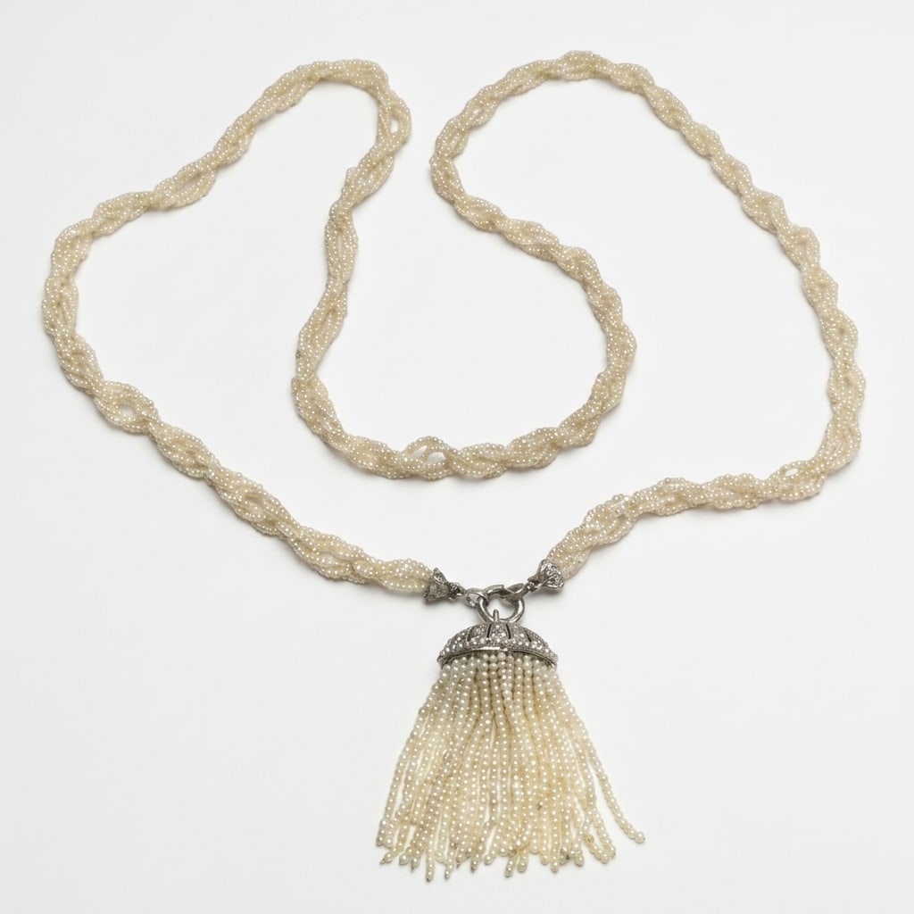 FANTASTIC PEARL SAUTOIR AND DIAMOND NECKLACE: FANTASTIC PEARL SAUTOIR AND DIAMOND NECKLACE,46.8 grams, testing platinum.The necklace of multi-row entwined pearls strands.Suspending a fine double sided diamond and pearl tassel drop.Set to the