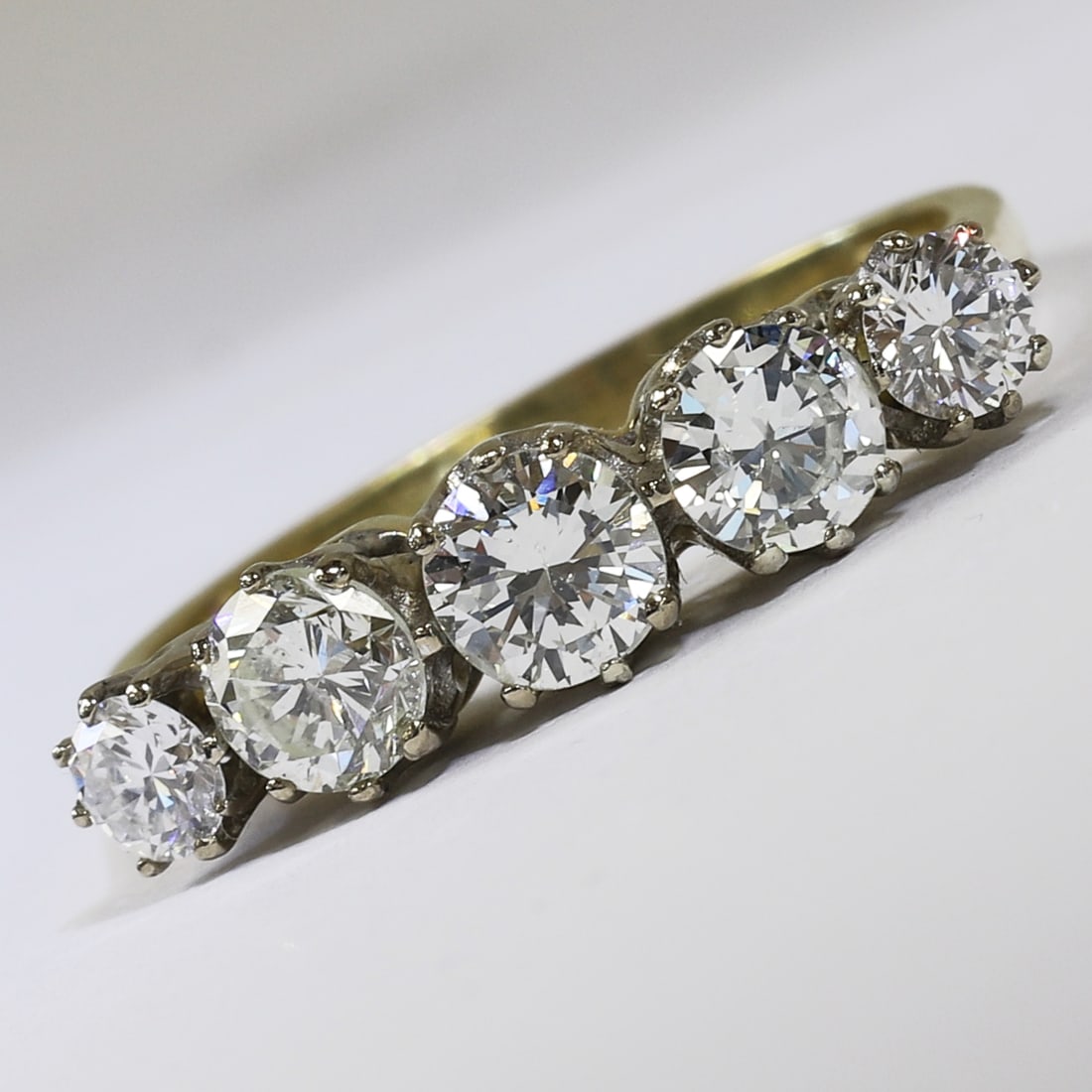 DIAMOND 5-STONE RING: DIAMOND 5-STONE RING,3.6 grams, 18 ct. gold.Diamonds bright and lively, totalling approx. 1..55 ct.Size O 1/2.