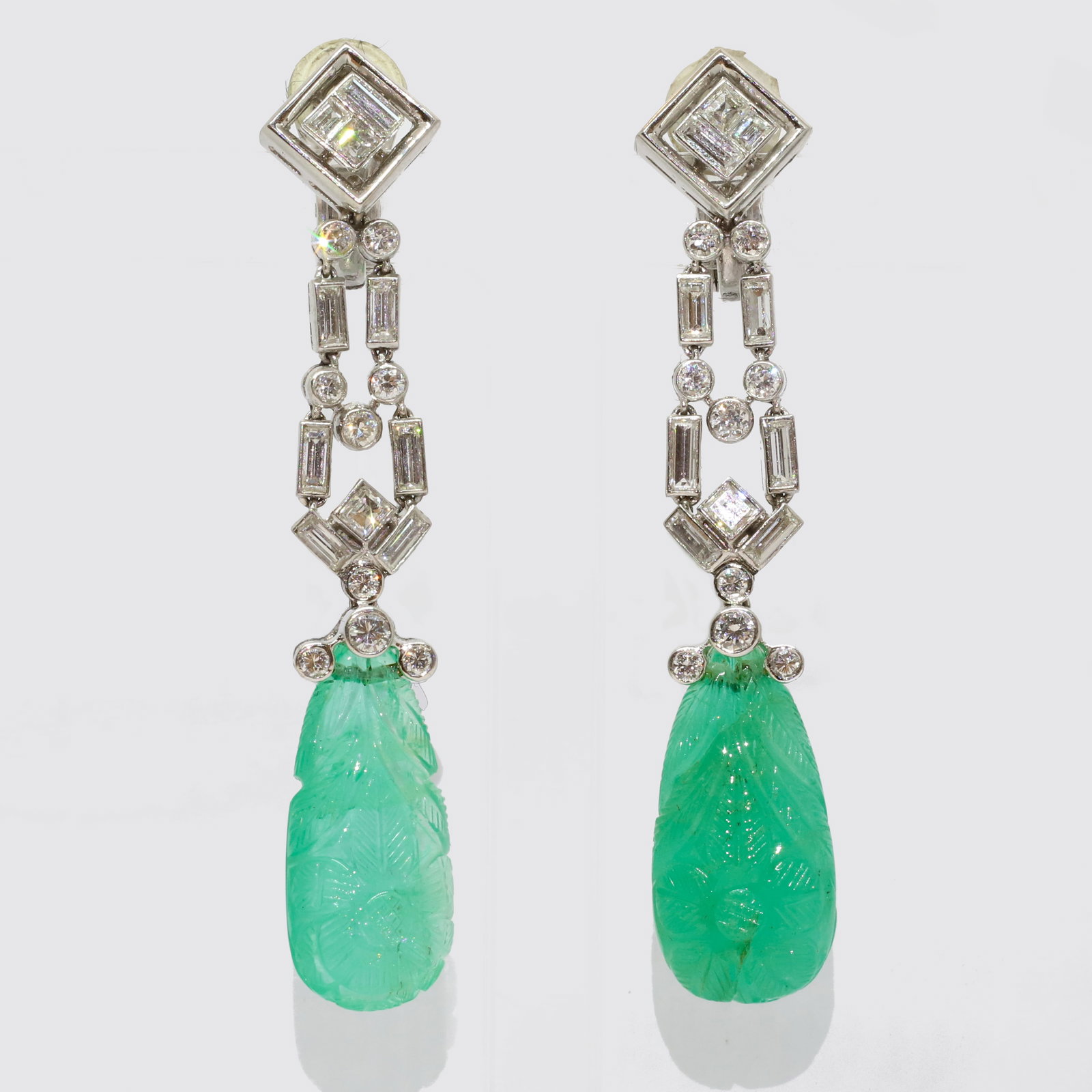 FANTASTIC PAIR OF ART-DECO EMERALD AND DIAMOND DROP EARRINGS: FANTASTIC PAIR OF ART-DECO EMERALD AND DIAMOND DROP EARRINGS,19.8 grams, testing platinum.Each earring suspending a fine mughal carved emerald, totalling approx. 36-40 ct.Suspending from an