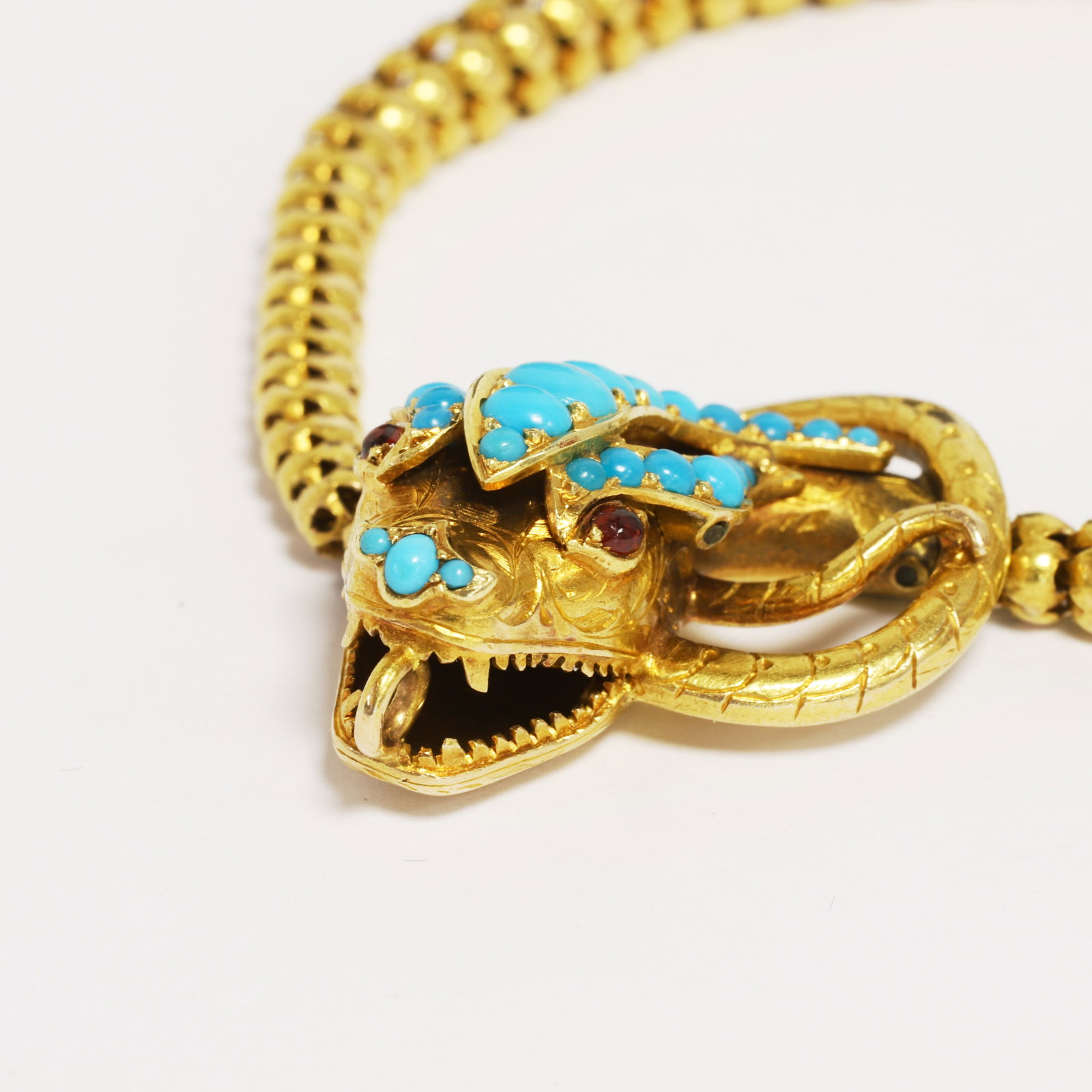 VICTORIAN TURQUOISE SNAKE BRACELET: VICTORIAN TURQUOISE SNAKE BRACELET,18.6 grams, testing high carat gold.The bracelet of fine snake link design.The head set with vibrant turquoise.L. 20 cm.