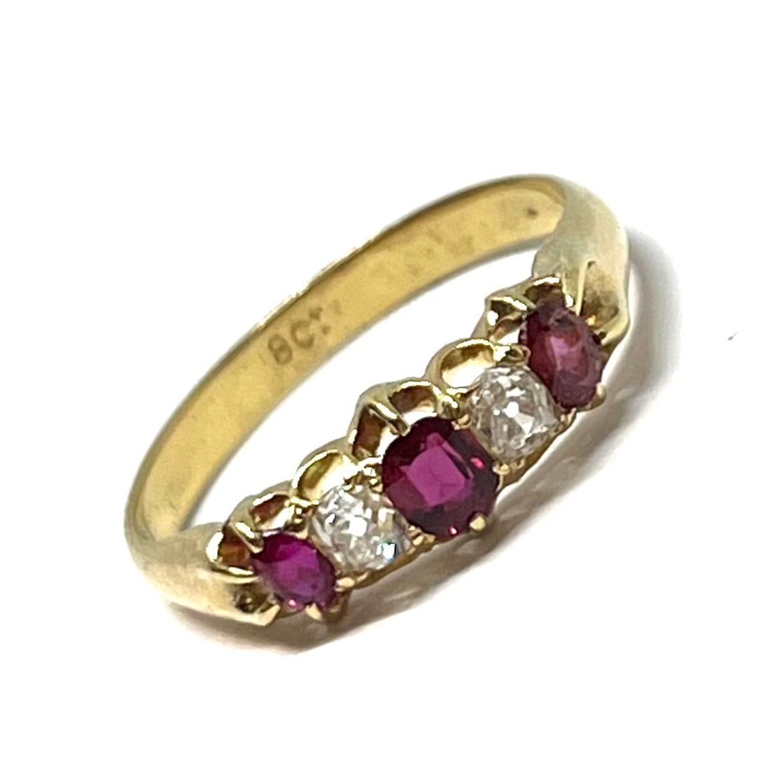 RUBY AND DIAMOND 5-STONE RING: RUBY AND DIAMOND 5-STONE RING,testing 18 ct. gold.Rich and vibrant rubies.Diamonds bright and lively.Size N 1/2.