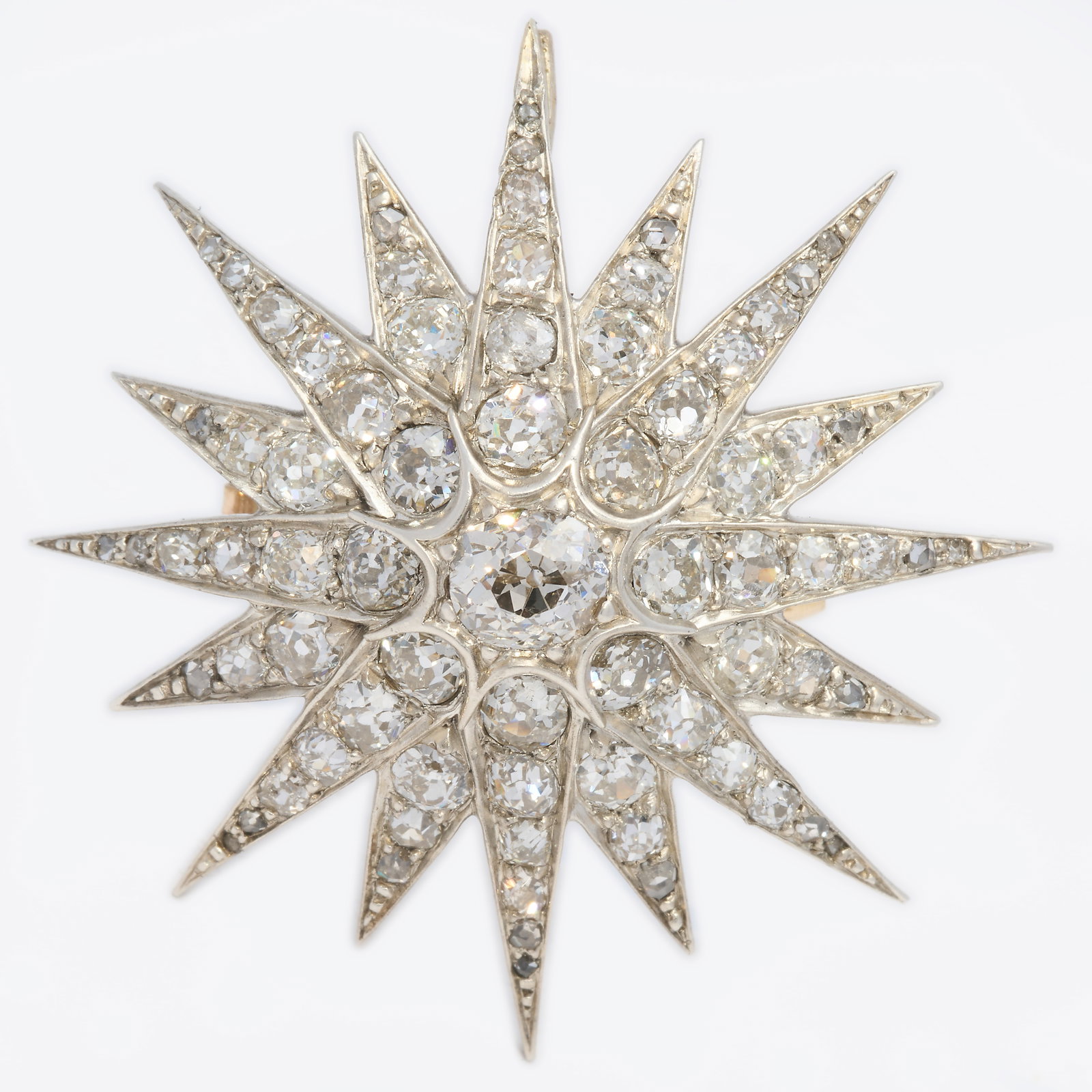 VICTORIAN DIAMOND STAR BROOCH: VICTORIAN DIAMOND STAR BROOCH,8.1 grams, testing high carat gold and silver.Bright and lively diamonds, totalling approx. 4.50 ct.W. 3.7 cm.
