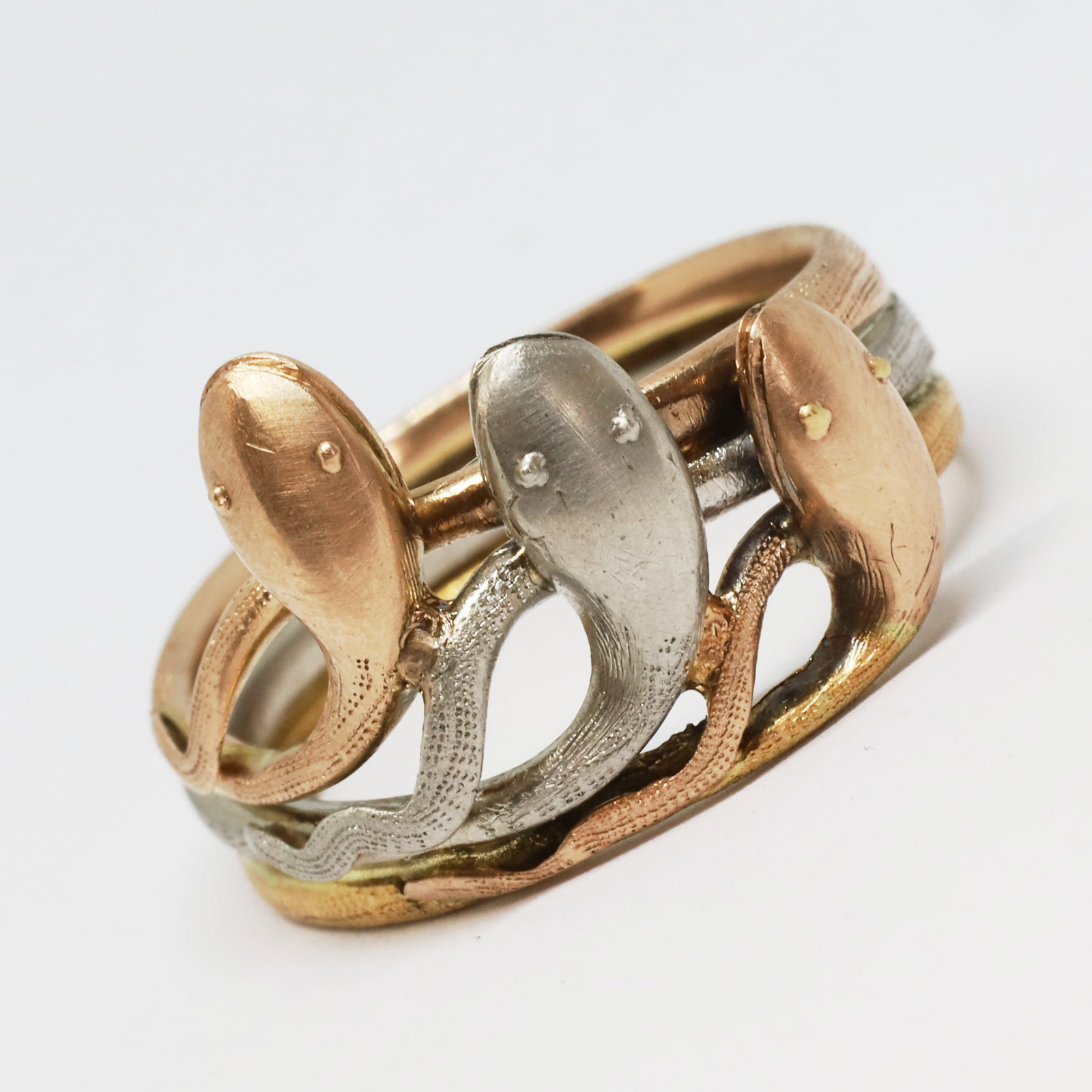 UNUSUAL 3-COLOUR GOLD TRIPLE SNAKE RING: UNUSUAL 3-COLOUR GOLD TRIPLE SNAKE RING,8 grams, testing high carat gold.Made in yellow, white and rose gold.Size L.