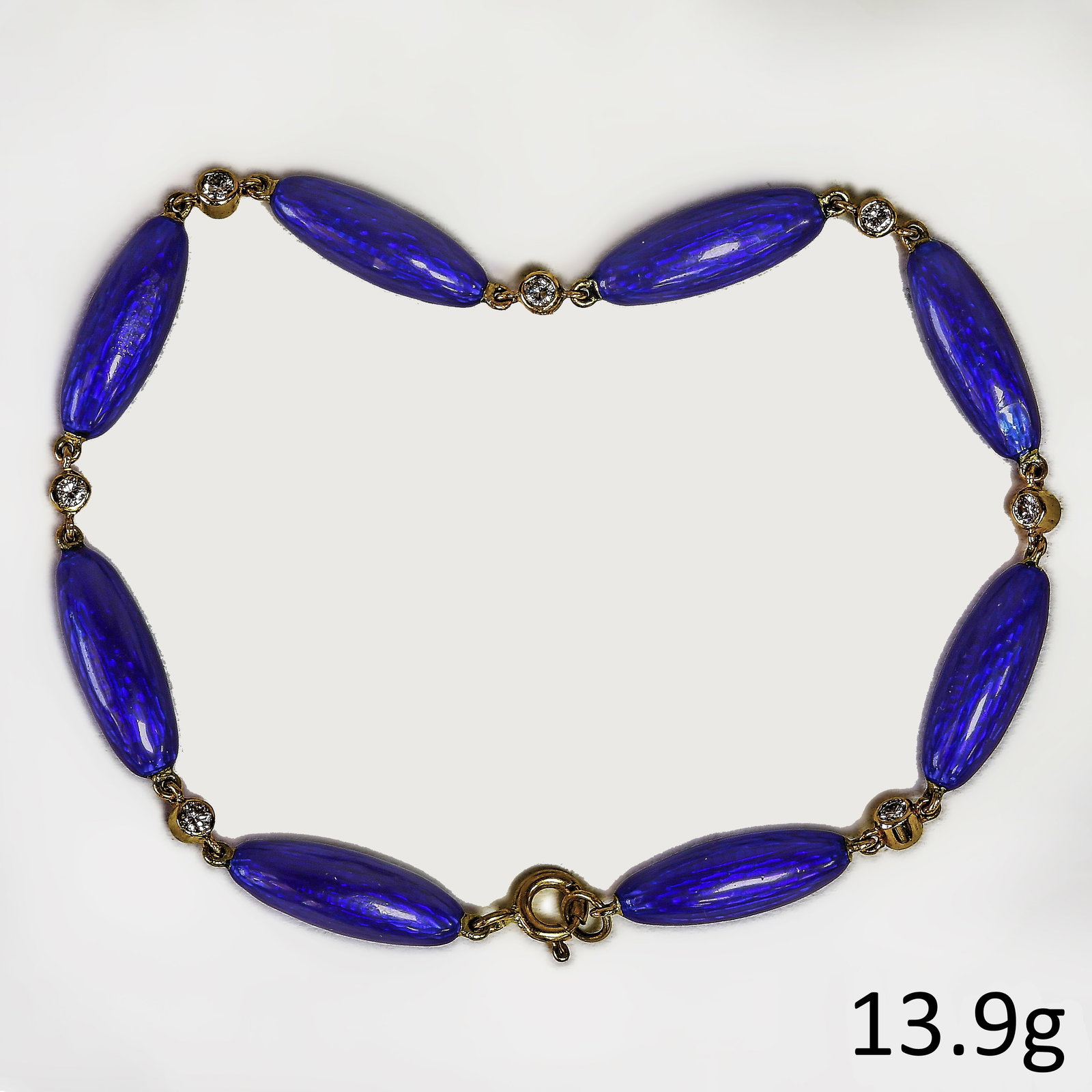 ANTIQUE ENAMEL AND DIAMOND BRACELET: ANTIQUE ENAMEL AND DIAMOND BRACELET,13,9 grams, testing 18 ct. gold.Rich blue enamel links (enamel good condition).Alternated with a diamond.L. 19.5 cm.