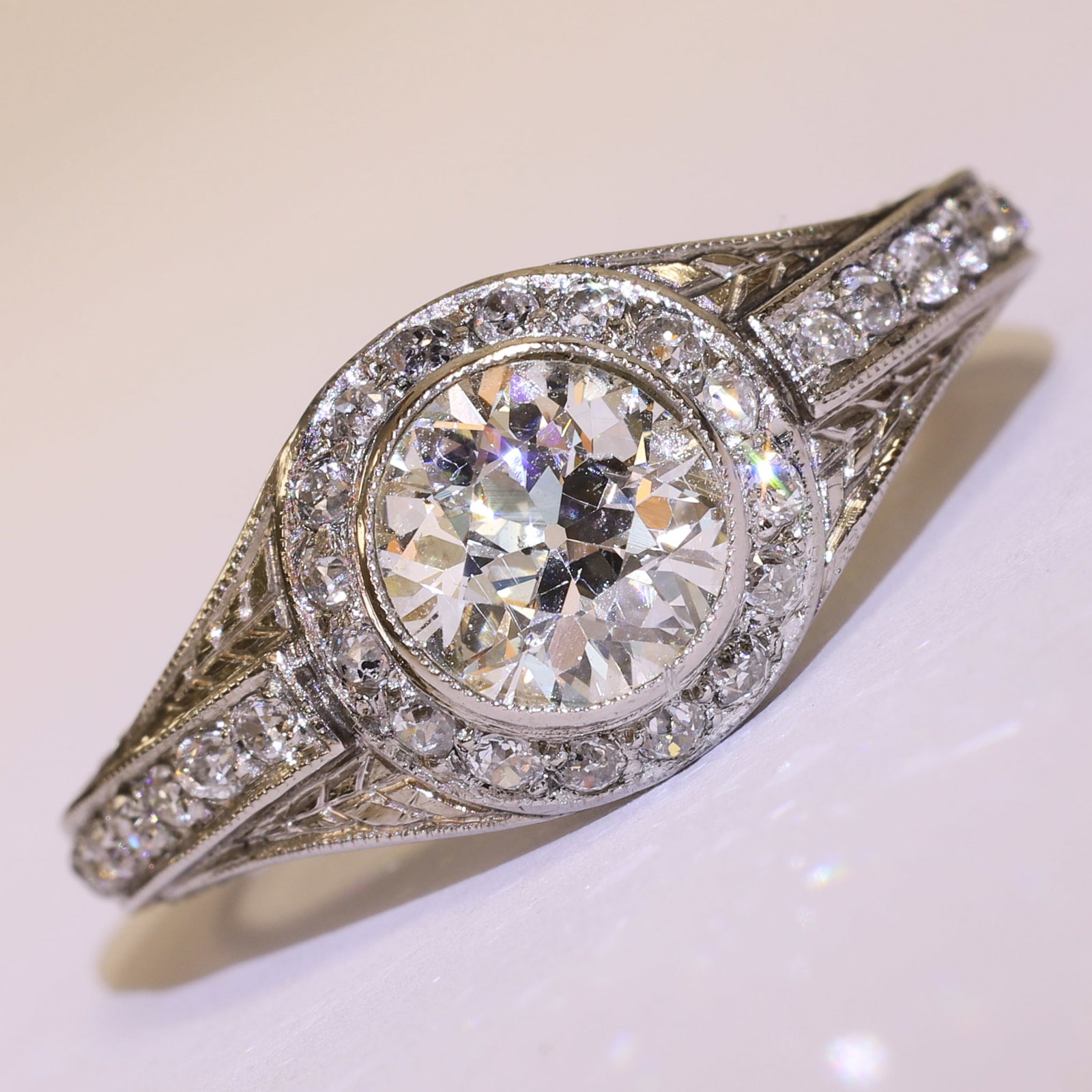 EDWARDIAN DIAMOND RING: EDWARDIAN DIAMOND RING,4,5 grams, testing platinum.Bright and lively old cut diamonds.Larger central diamond, flanked with diamonds on the shoulders and the sides of the head.Totalling approx. 2.15