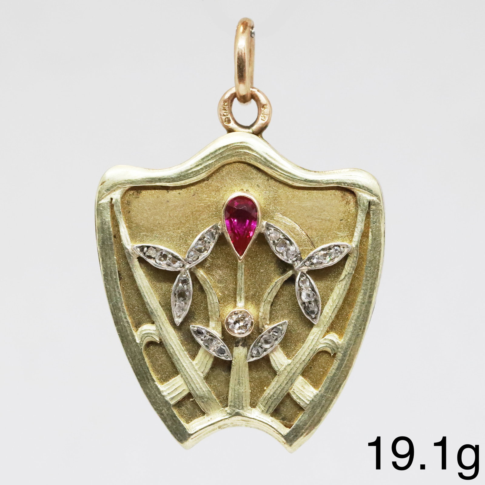 ART-NOUVEAU RUSSIAN RUBY AND DIAMOND LOCKET PENDANT: ART-NOUVEAU RUSSIAN RUBY AND DIAMOND LOCKET PENDANT,19.1 grams, testing high carat gold.Rich and vibrant ruby.Diamonds bright and lively.Indistinct marked.L. 4.7 cm.