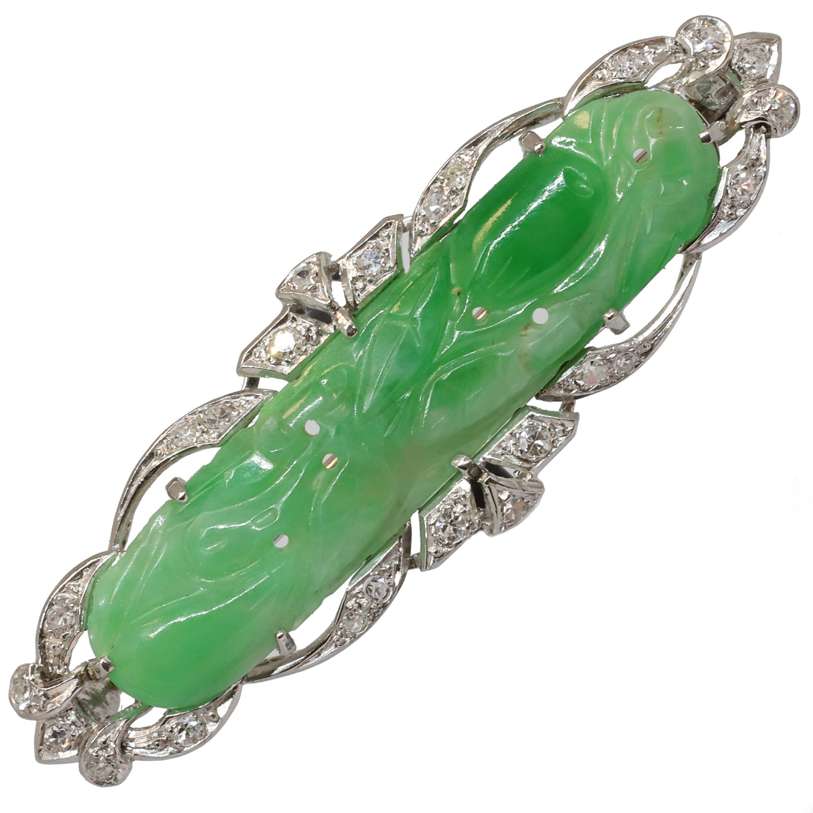 ART-DECO JADE AND DIAMOND BROOCH: ART-DECO JADE AND DIAMOND BROOCH,8,6 grams, testing platinum.Diamonds bright and lively.Lovely carved green jade plaque.W. 5.3 cm.Fitted Liberty case.