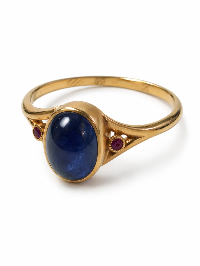 VICTORIAN SAPPHIRE AND RUBY RING: VICTORIAN SAPPHIRE AND RUBY RING,4 grams, testing high carat gold.rich and vibrant cabochon cut sapphire of approx. 4.40 ct.Accentuated with rubies on the shoulders.Size P 1/2.