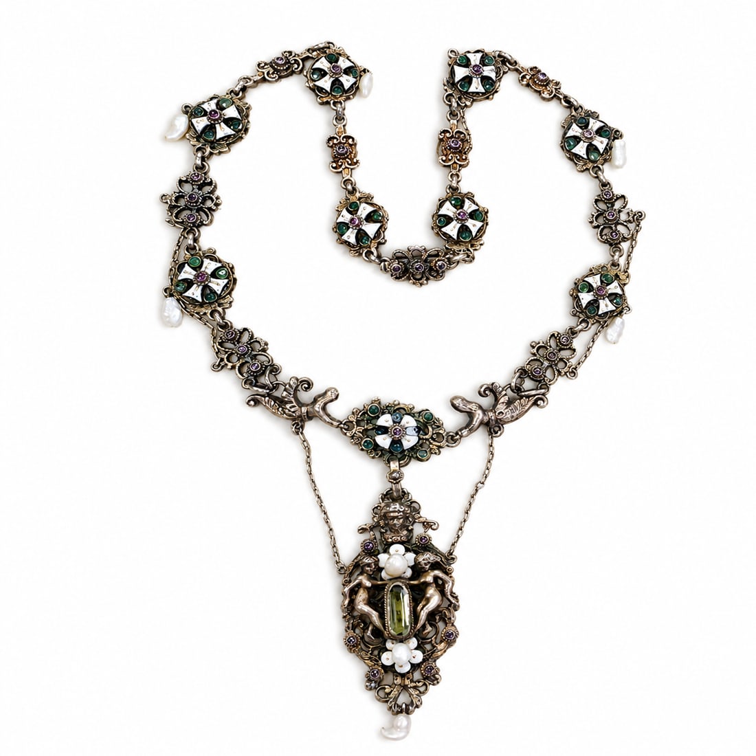 RARE AND UNUSUAL ANTIQUE ENAMEL AND PEARL FIGURAL NECKLACE: RARE AND UNUSUAL ANTIQUE ENAMEL AND PEARL FIGURAL NECKLACE,54.3 grams.The necklace with fine enamel and emerald accents.Suspending a larger drop with a peridot, enamel and pearls.L. 43 cm.Antique fitt