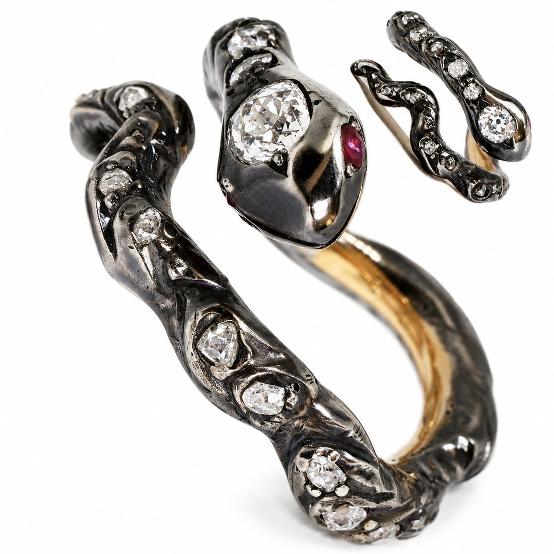 UNUSUAL DIAMOND SNAKE RING: UNUSUAL DIAMOND SNAKE RING,9.7 grams, testing high carat gold and silver.Diamonds bright and lively, with a larger old cut diamond to the head.Size N.