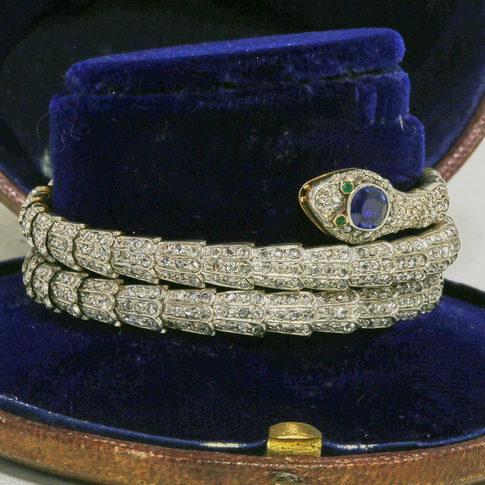 IMPORTANT VICTORIAN DIAMOND AND SAPPHIRE SPRING SNAKE BANGLE: IMPORTANT VICTORIAN DIAMOND AND SAPPHIRE SPRING SNAKE BANGLE,62,4 grams.The snake of 3 coil design.Fully set with bright and lively diamonds.The head of the snake set with a rich and vibrant sapphire.