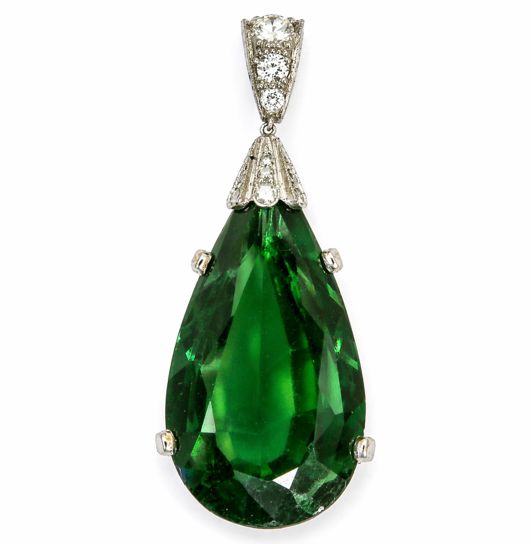 FINE TOURMALINE AND DIAMOND PENDANT: FINE TOURMALINE AND DIAMOND PENDANT,8..3 grams, testing high carat gold.Large pear shaped green tourmaline, of approx. 22.65 ct.Diamonds bright and lively.L. 4.6 cm.