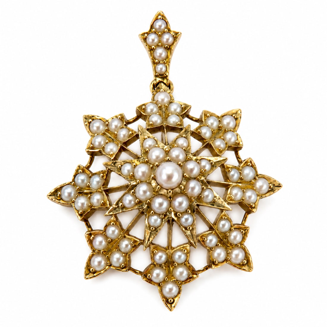 VICTORIAN PEARL STAR BROOCH/PENDANT: VICTORIAN PEARL STAR BROOCH/PENDANT,6 grams, testing high carat gold.Pearls generally well matched.Removable bail.L. 3.6 cm.Fitted case.