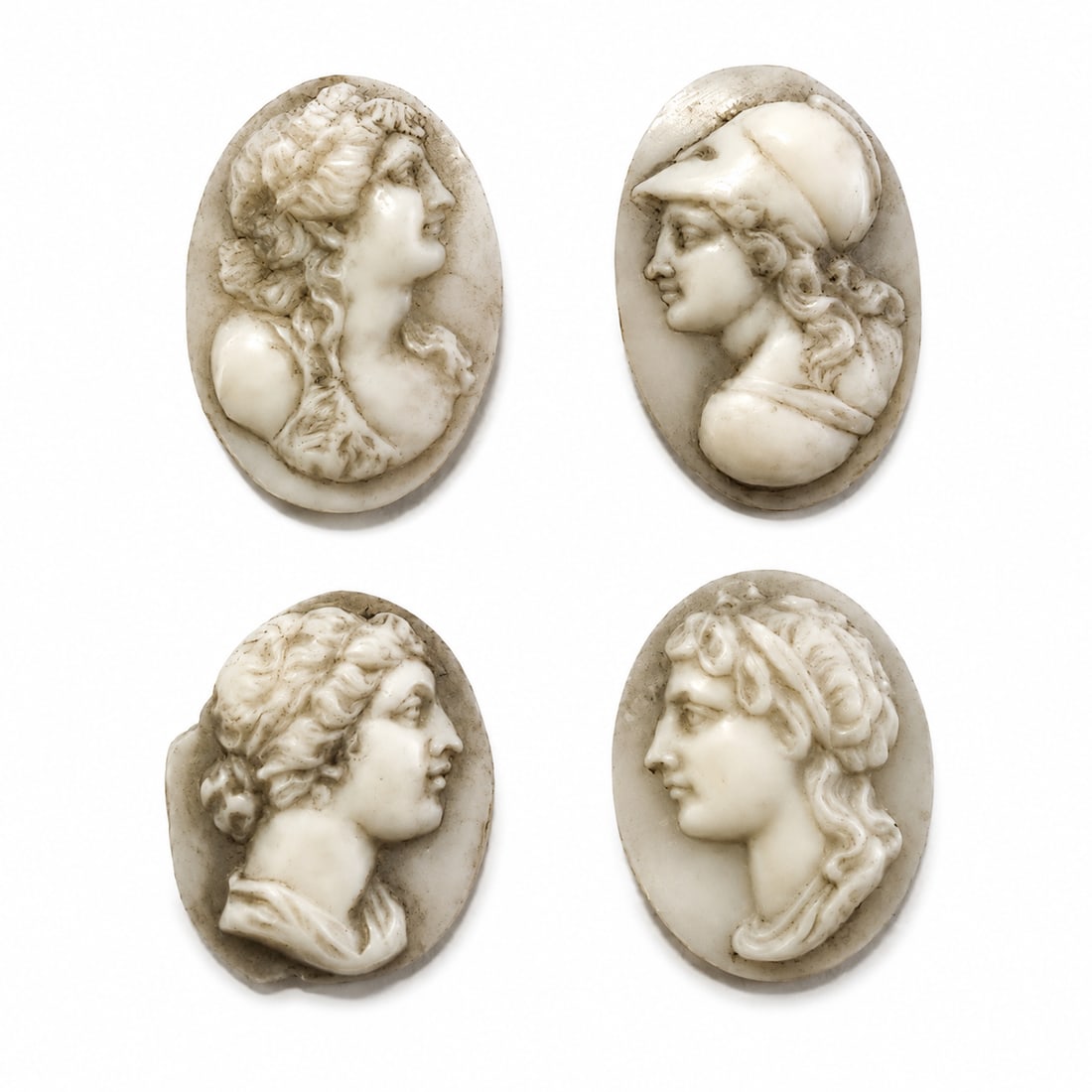 LOT OF 4 CARVED SHELL CAMEO'S: LOT OF 4 CARVED SHELL CAMEO'S,Depicting classical heads, including Minerva.Largest 2,4 cm.