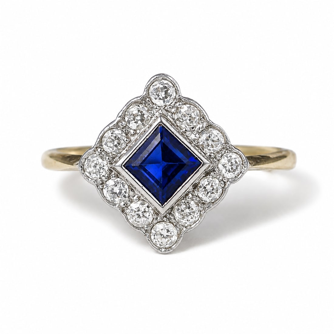 SAPPHIRE AND DIAMOND CLUSTER RING: SAPPHIRE AND DIAMOND CLUSTER RING,18 ct. gold.Rich and vibrant sapphire.Diamonds bright and lively.Size Q 1/2.