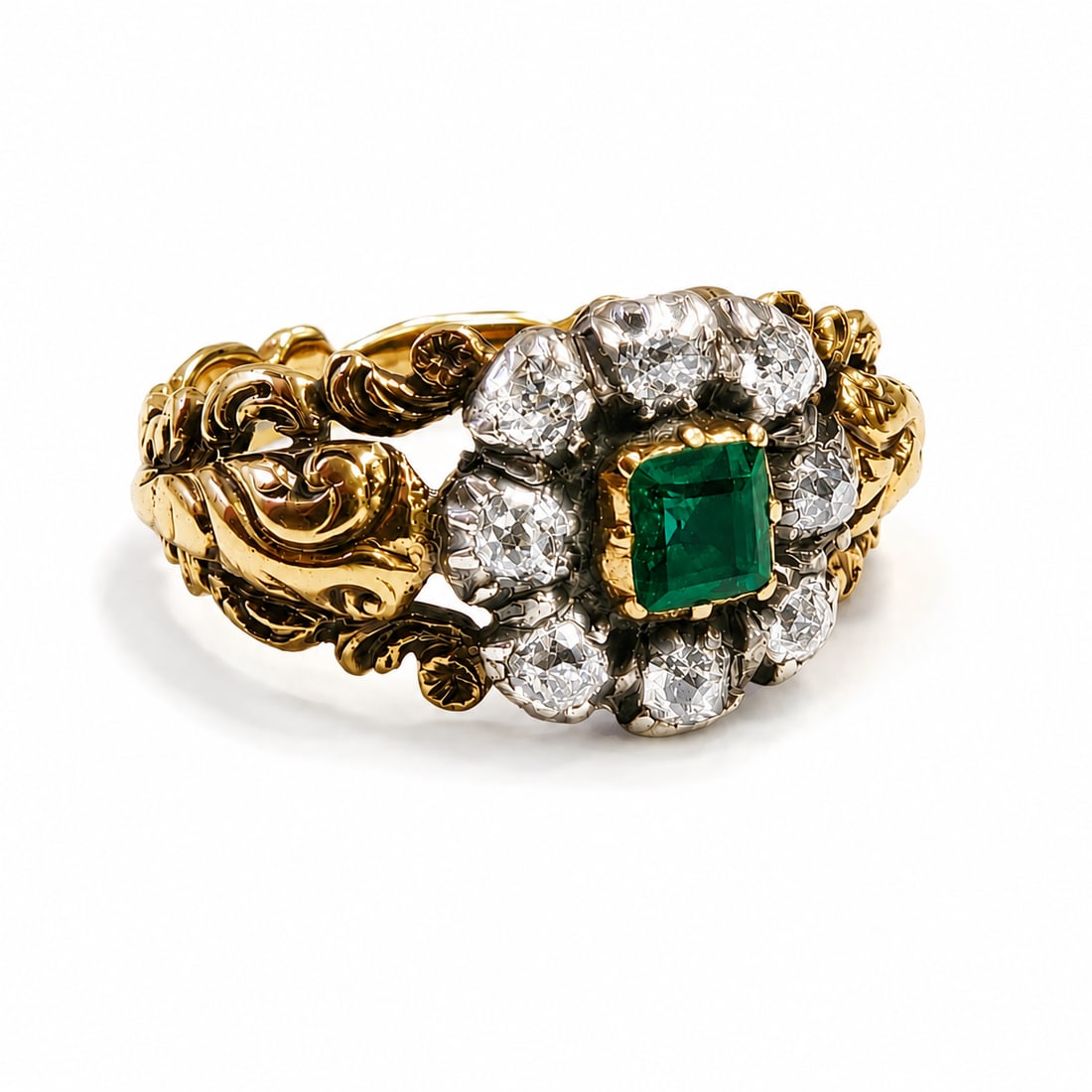 GEORGIAN EMERALD AND DIAMOND CLUSTER RING: GEORGIAN EMERALD AND DIAMOND CLUSTER RING,3,5 grams, testing high carat gold and silver.Rich and vibrant emerald, likely Colombian.Diamonds bright and lively.Fine relief detailed shank.Size K 1/2.