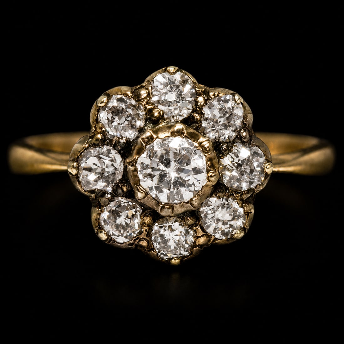 DIAMOND DAISY CLUSTER RING: DIAMOND DAISY CLUSTER RING,4 grams, 18 ct. gold.Bright and lively old cut diamonds, totalling approx. 1.20 ct.Size M.
