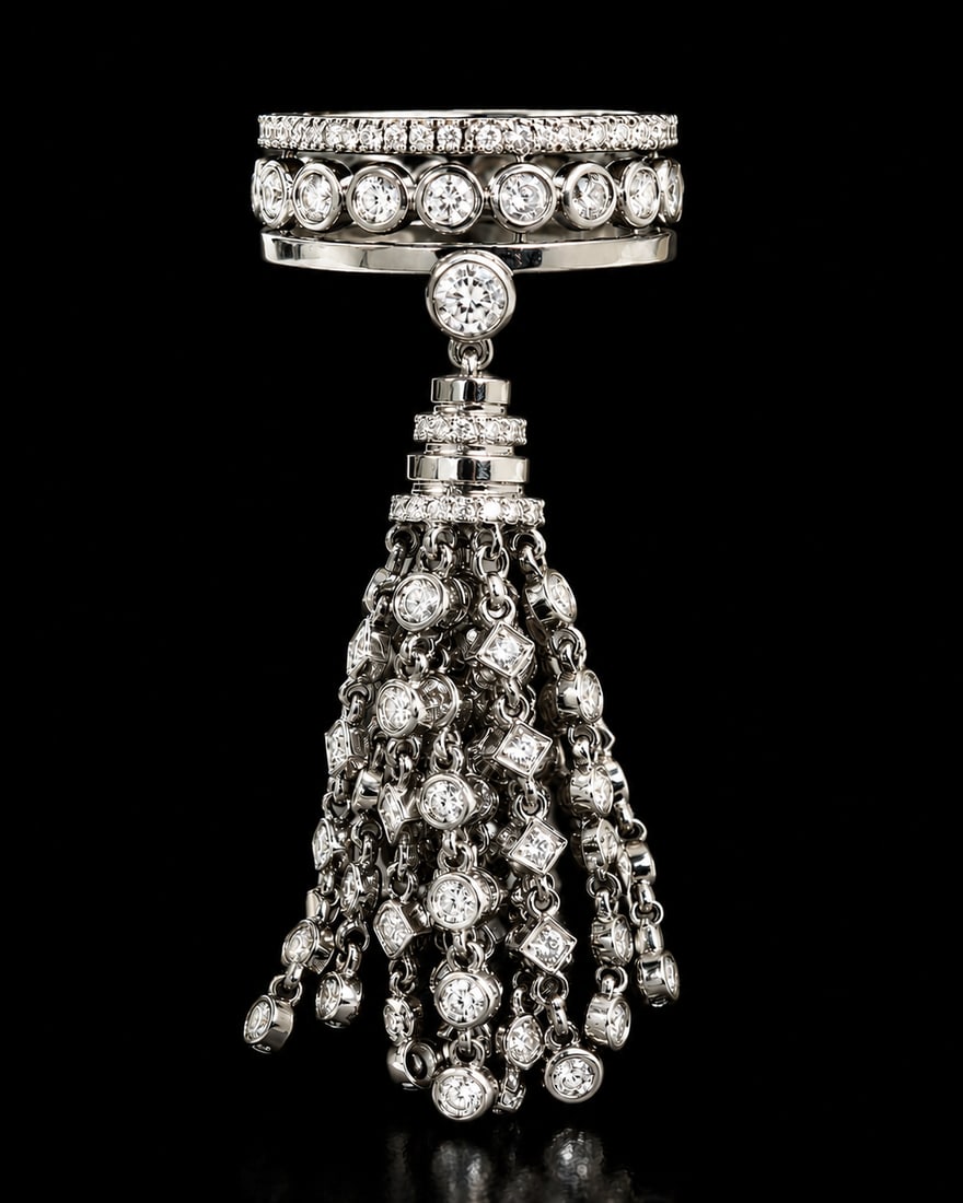 MESSIKA X KATE MOSS. UNUSUAL DIAMOND TASSEL RING: MESSIKA X KATE MOSS. UNUSUAL DIAMOND TASSEL RING,14.1 grams, 18 ct. gold.Diamond ring with unusual diamond set tassel drop.Signed Messika X Kate Moss.Size H.