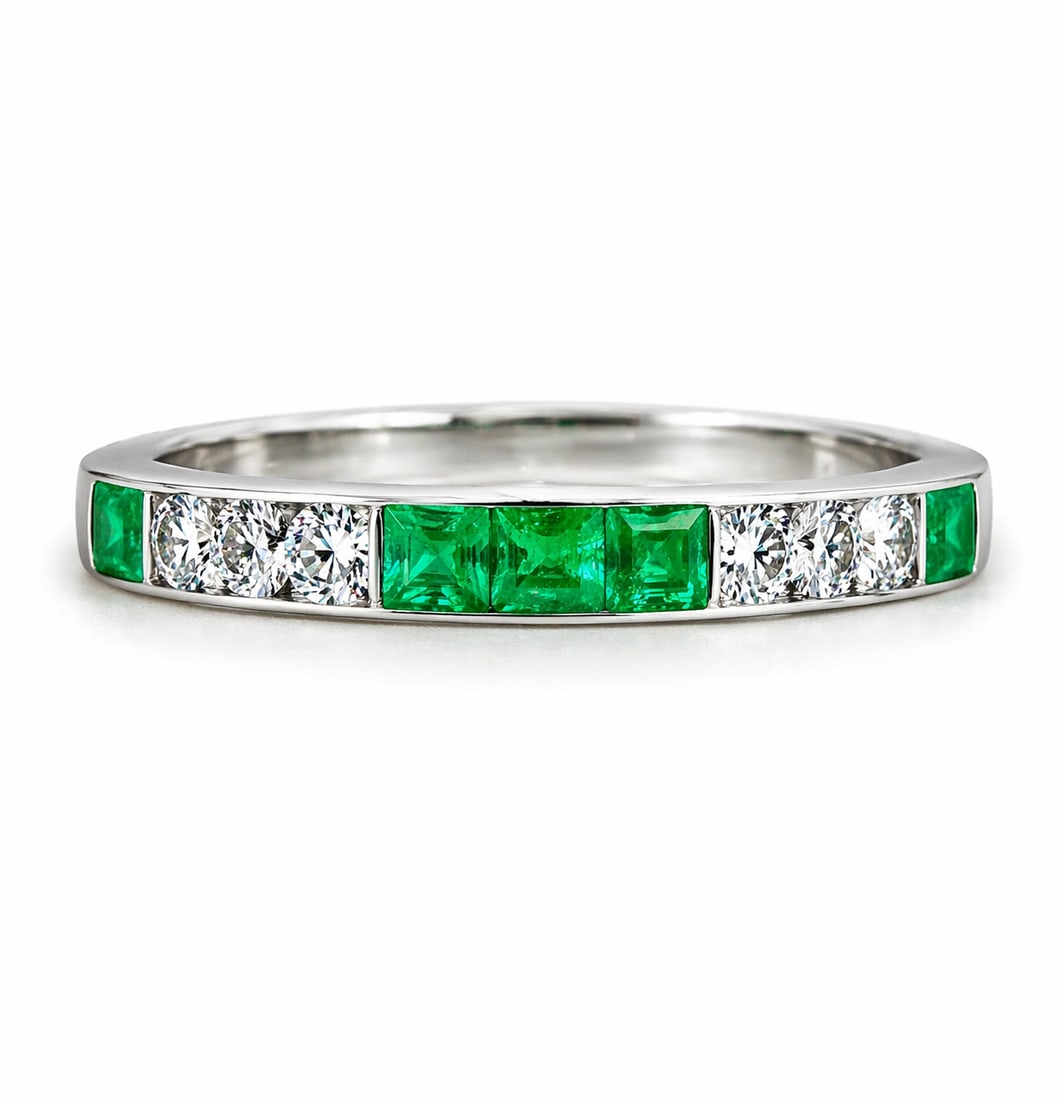 EMERALD AND DIAMOND FULL ETERNITY RING: EMERALD AND DIAMOND FULL ETERNITY RING,4,1 grams, testing high carat gold.Rich and vibrant emeralds, totalling approx. 0.70 ct.Diamonds bright and lively, totalling approx. 0.50 ct.Size Q 1/2.