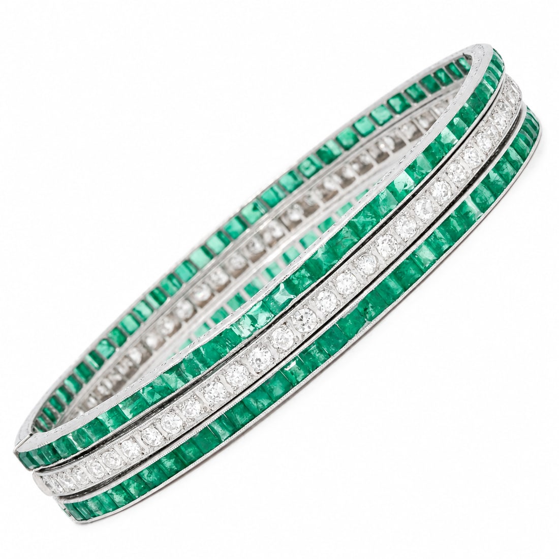EXQUISITE SET OF 3 ART-DECO EMERALD AND DIAMOND HINGED BRACELETS: EXQUISITE SET OF 3 ART-DECO EMERALD AND DIAMOND HINGED BRACELETS,50 grams, platinum.2 bangles fully set with emeralds, totalling approx. 11 ct.1 bangle fully set with diamonds, totalling approx. 4.75 