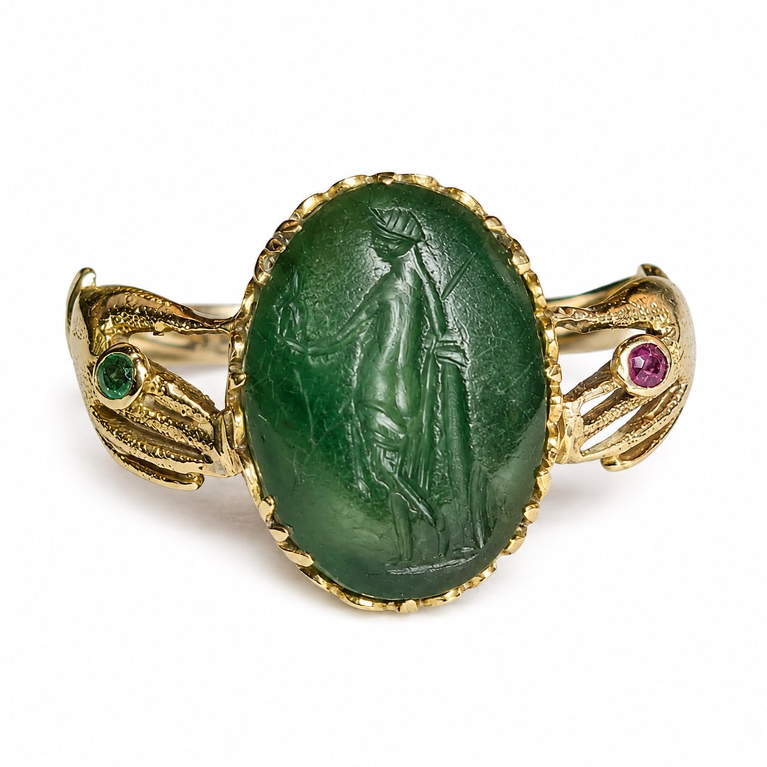 VICTORIAN INTAGLIO HAND RING: VICTORIAN INTAGLIO HAND RING,testing 18 ct. gold.Lovely carved hardstone intaglio.The shoulders in the shape of a hand, set with a ruby and emerald.Size K 1/2.