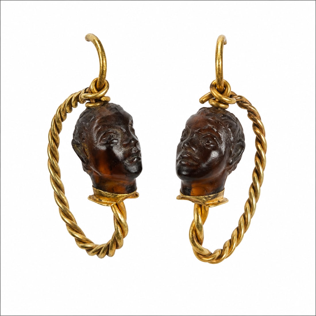 FANTASTIC PAIR OF ROMAN GOLD AND GARNET CARVED EARRINGS: FANTASTIC PAIR OF ROMAN GOLD AND GARNET CARVED EARRINGS,12.1 grams, testing high carat gold.By repute 2nd - 3rd Century AD.The earrings of twisted entwined wire design.Each featuring a fantastic