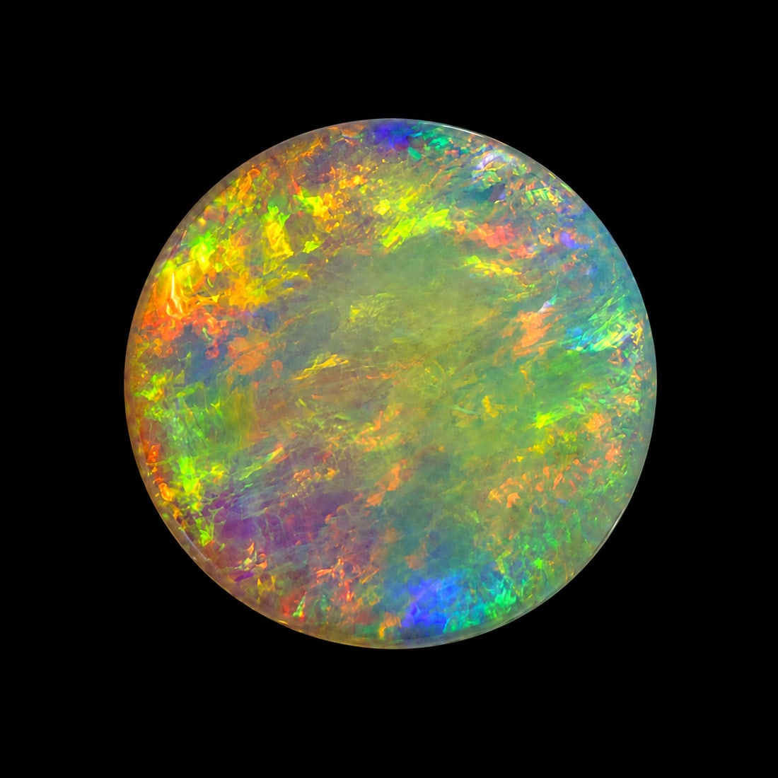 LOOSE CUT OPAL OF APPROX. 3.50 CT.: LOOSE CUT OPAL OF APPROX. 3.50 CT.Good play of colour including red.Diam. 14 mm.