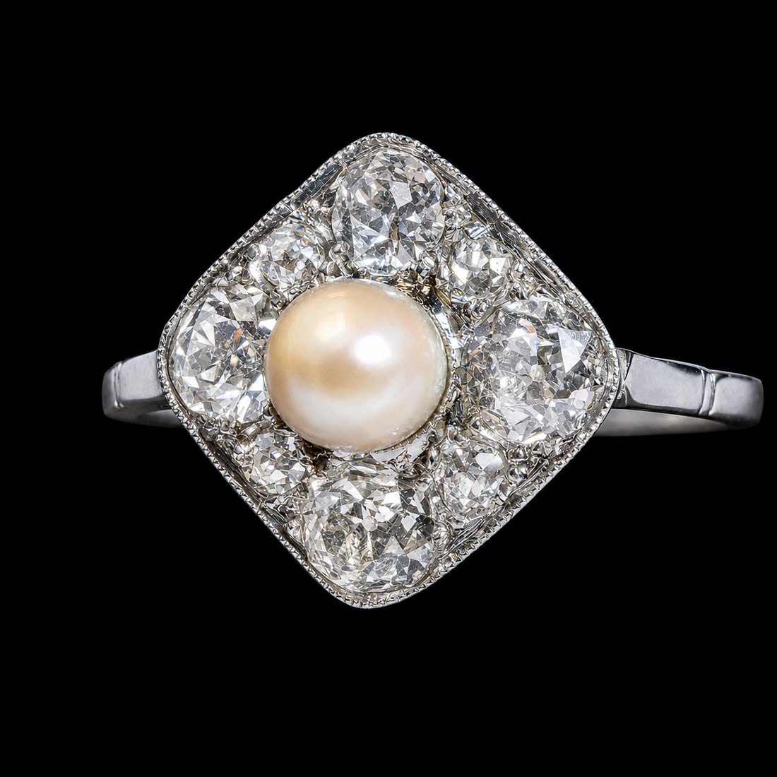 ART-DECO PEARL AND DIAMOND CLUSTER RING: ART-DECO PEARL AND DIAMOND CLUSTER RING,3.1 grams, testing platinum.Bright and lively old cut diamonds, totalling approx. 1.20 ct.Lovely pearl to the centre (untested, believed to be natural).Size P.