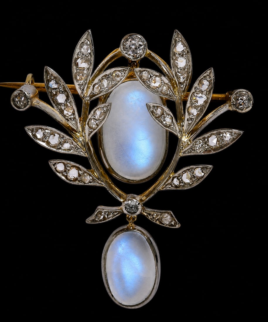 VICTORIAN MOONSTONE AND DIAMOND BROOCH: VICTORIAN MOONSTONE AND DIAMOND BROOCH,8.1 grams, Testing high carat gold and silver.Diamonds bright and lively.Locley articulated moonstones, with nice blue shiller.L. 3.5 cm.