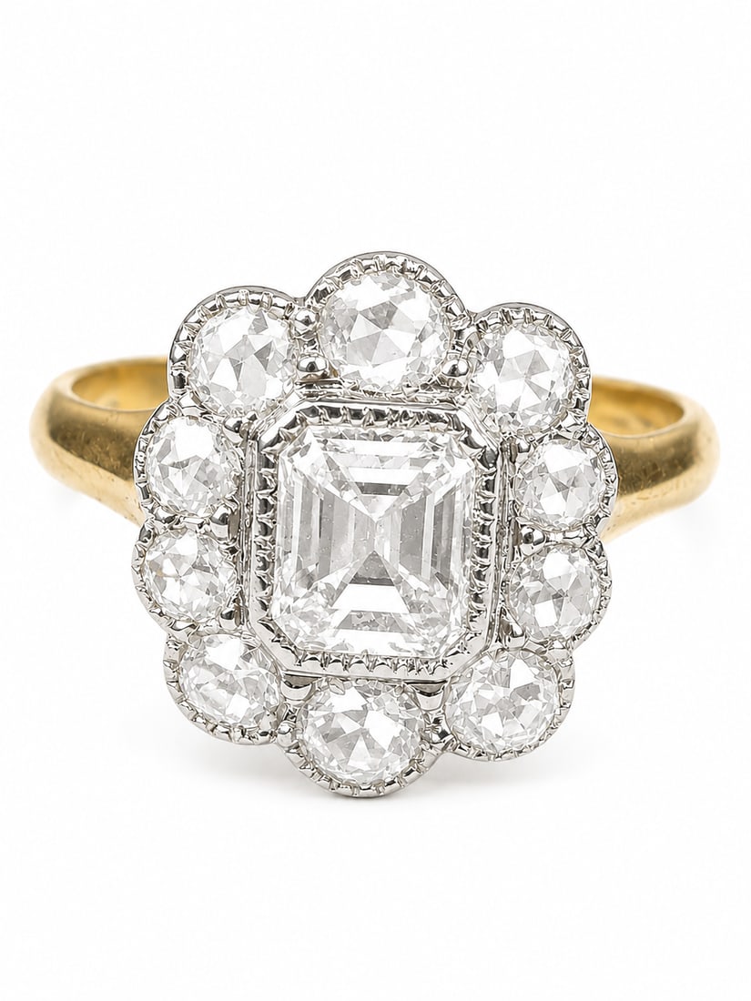 DIAMOND CLUSTER RING: DIAMOND CLUSTER RING,3,2 grams, testing 18 ct. gold and platinum.Lovely emerald cut diamond in the centre.Diamonds totalling approx. 1.35 ct.Size O.