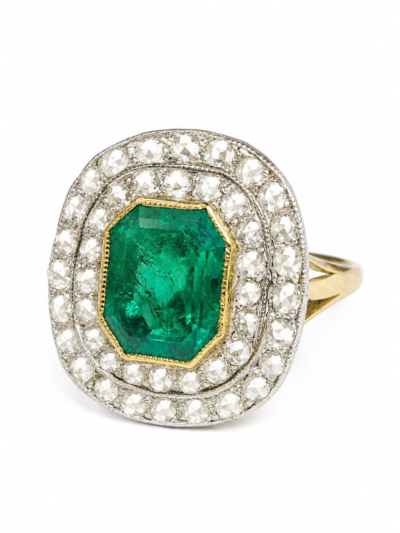 EMERALD AND DIAMOND CLUSTER RING: EMERALD AND DIAMOND CLUSTER RING,3,7 grams, testing 18 ct. gold and platinum.Rich and vibrant emerald of approx. 1.80 ct.Diamonds bright and lively in a double halo cluster.Size M.