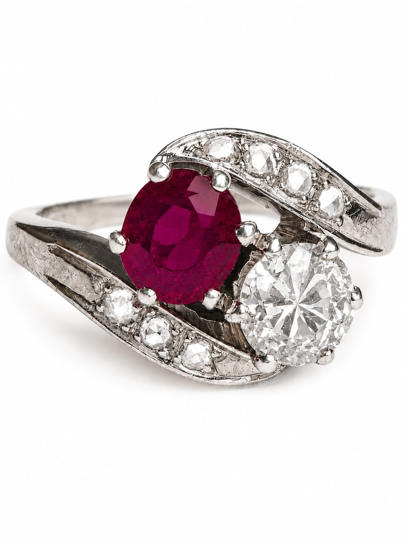 RUBY AND DIAMOND TOI-ET-MOI TWIST RING: RUBY AND DIAMOND TOI-ET-MOI TWIST RING,5,8 grams, testing 18 ct. gold.Rich and vibrant ruby.Diamonds bright and lively.Size O,