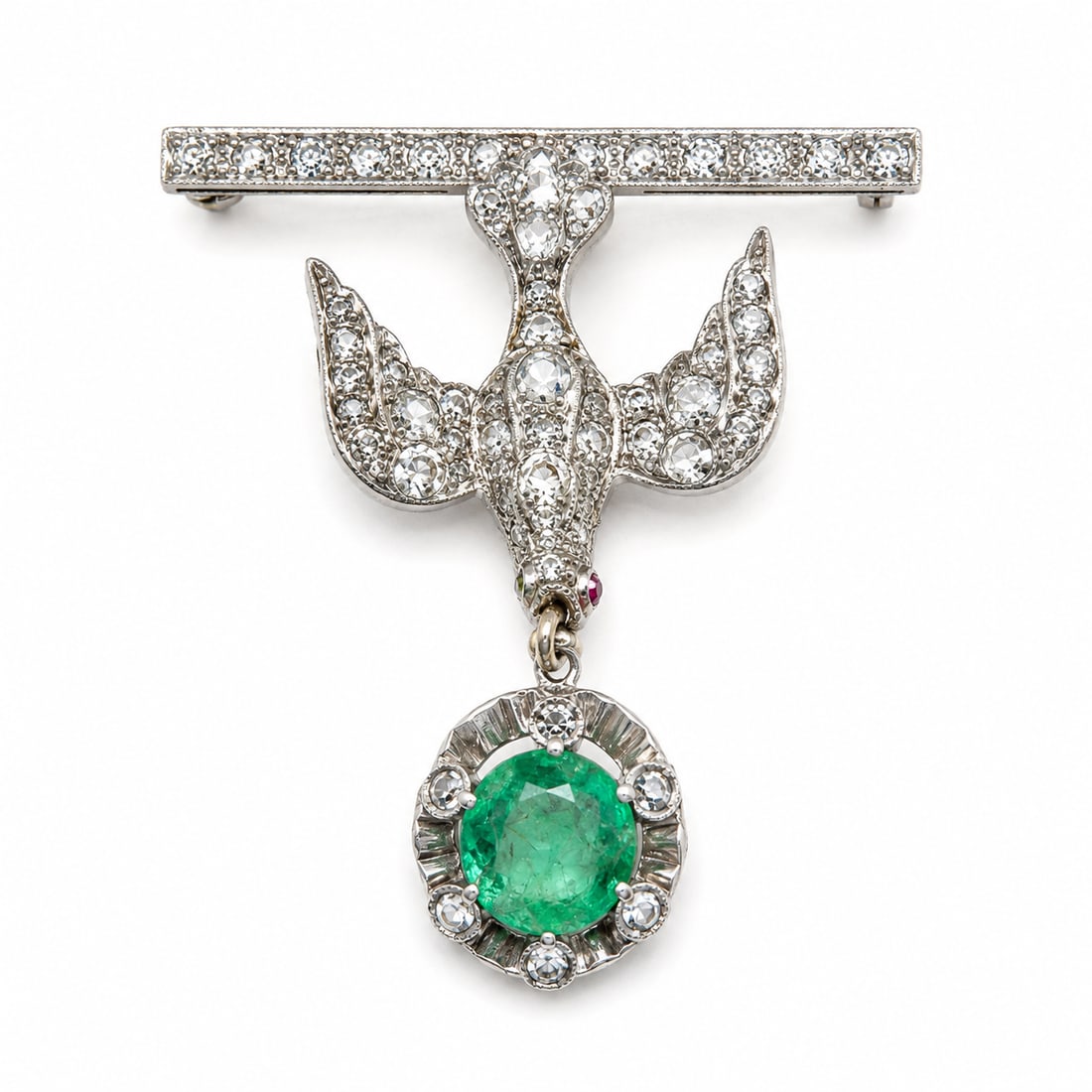 ANTIQUE EMERALD AND DIAMOND BIRD BROOCH: ANTIQUE EMERALD AND DIAMOND BIRD BROOCH,6,3 grams, testing high carat gold and silver.Diamonds bright and lively.The bird suspending an emerald from its mouth of approx. 0.95 ct.L. 3.7 cm.