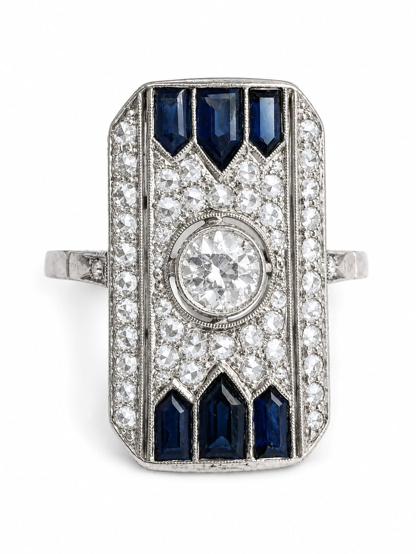 FINE ART-DECO SAPPHIRE AND DIAMOND RING: FINE ART-DECO SAPPHIRE AND DIAMOND RING,6,8 grams, testing platinum.Bright and lively diamonds.Rich and vibrant sapphires.L. head 2.2 cm.Size O 1/2.