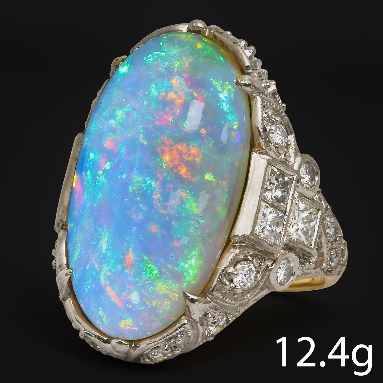 LARGE OPAL AND DIAMOND RING RING: LARGE OPAL AND DIAMOND RING RING,12,4 grams, 18 ct. gold.Fine cabochon cut opal of approx. 11.40 ct.Good play of colour including red.Diamonds bright and lively.L. head 2.6 cm.Size N.