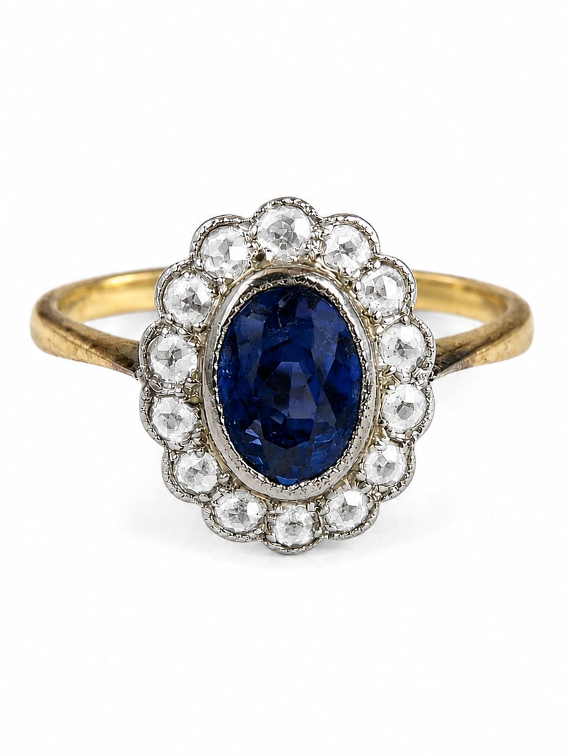 SAPPHIRE AND DIAMOND CLUSTER RING: SAPPHIRE AND DIAMOND CLUSTER RING,testing 18 ct. gold and platinum.Rich and vibrant sapphire of approx. 1.10 ct.Size M 1/2.