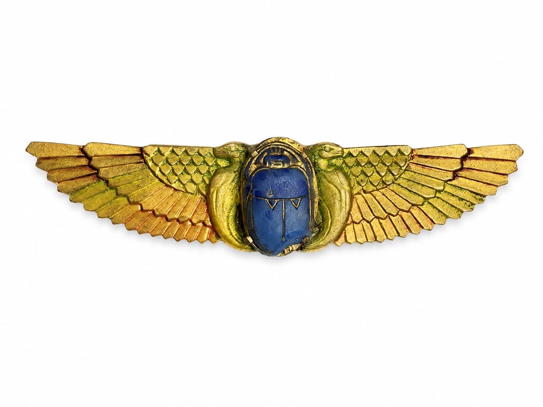VICTORIAN EGYPTIAN REVIVAL WINGED SCARAB BROOCH: VICTORIAN EGYPTIAN REVIVAL WINGED SCARAB BROOCH6.5 grams, testing gold. The central carved hardstone scarab flanked by two enamelled wings.W. 5.7 cm.