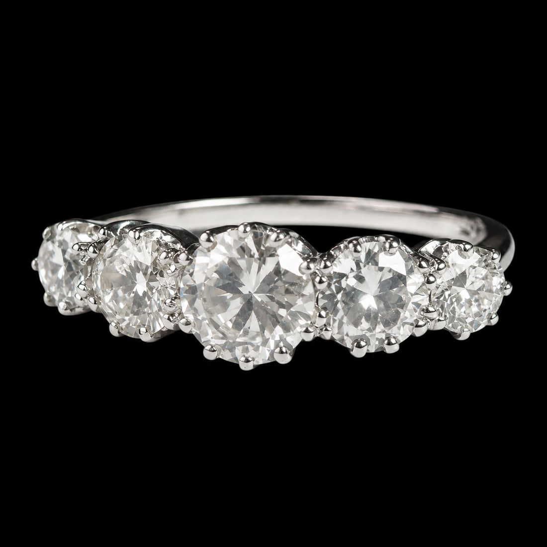 5-STONE DIAMOND RING: 5-STONE DIAMOND RING,3.6 grams, testing platinum.Diamonds bright and lively, totalling approx. 1.85 ct.Size M.
