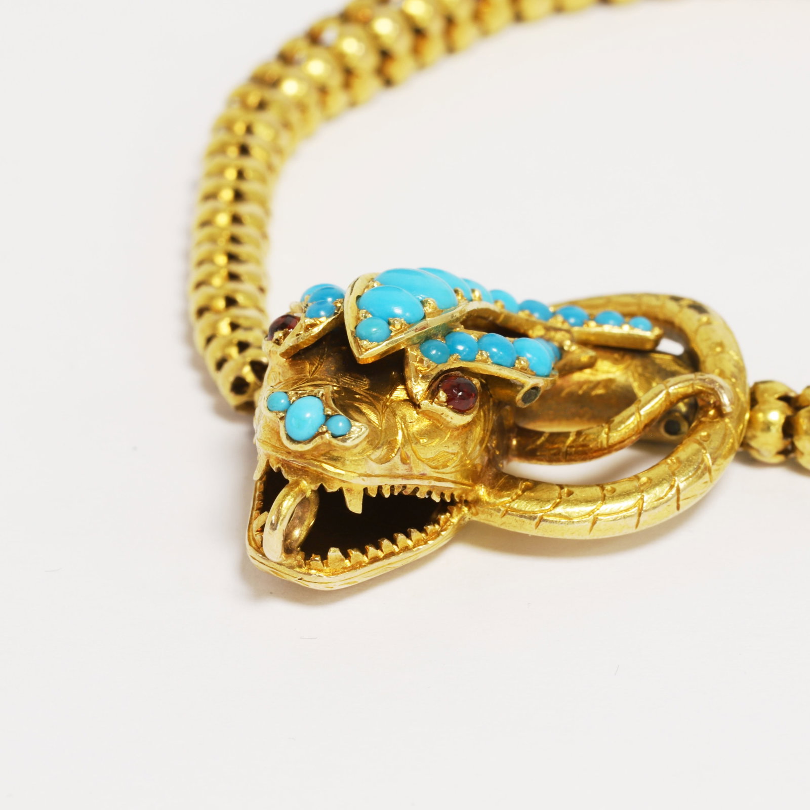 VICTORIAN TURQUOISE SNAKE BRACELET: VICTORIAN TURQUOISE SNAKE BRACELET,18.6 grams, testing high carat gold.The bracelet of fine snake link design.The head set with vibrant turquoise.L. 20 cm.