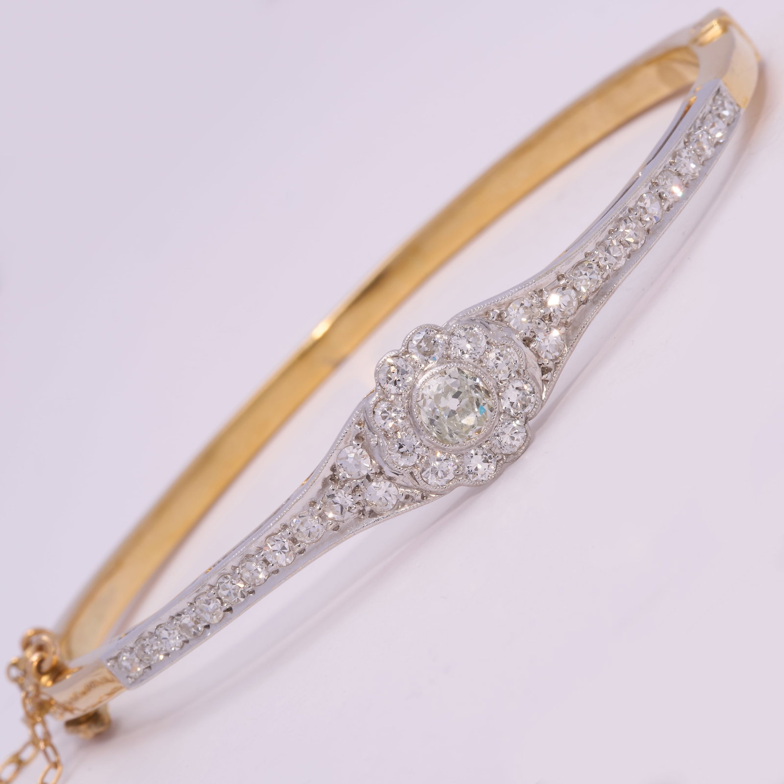 EDWARDIAN DIAMOND HINGED BANGLE: EDWARDIAN DIAMOND HINGED BANGLE 10.5 grams high carat gold and platinum bright lively old cut diamonds no dents in great condition