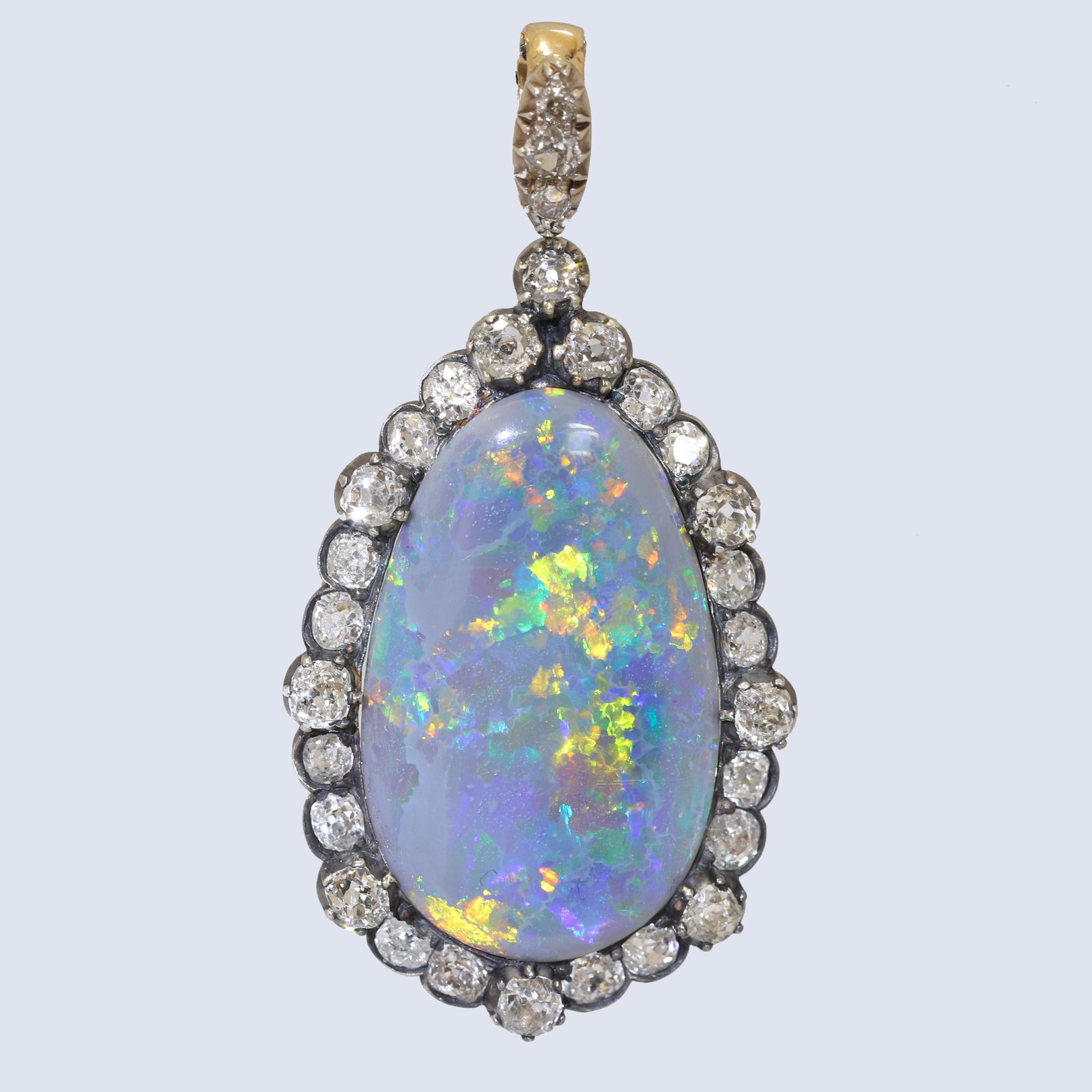 FANTASTIC ANTIQUE BLACK OPAL AND DIAMOND PENDANT: FANTASTIC ANTIQUE BLACK OPAL AND DIAMOND PENDANT,8,5 grams, testing high carat gold and silver.Fantastic large black opal of approx. 16 ct. with great play of colour.Bright and lively old cut diamonds