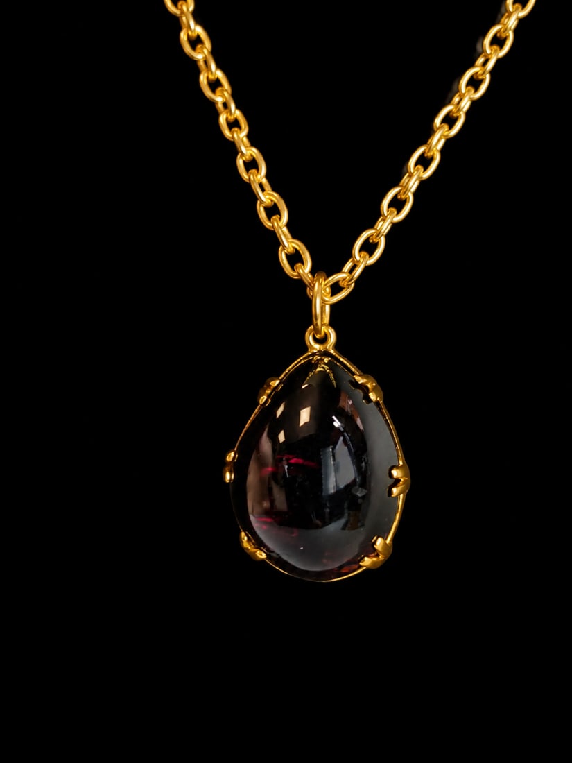 VICTORIAN GARNET PENDANT NECKLACE: VICTORIAN GARNET PENDANT NECKLACE,17.4 grams. Pendant testing 15 carat gold with yellow metal chain.Lovely pear cabochon cut garnet.L. pendant 2.9 cm.