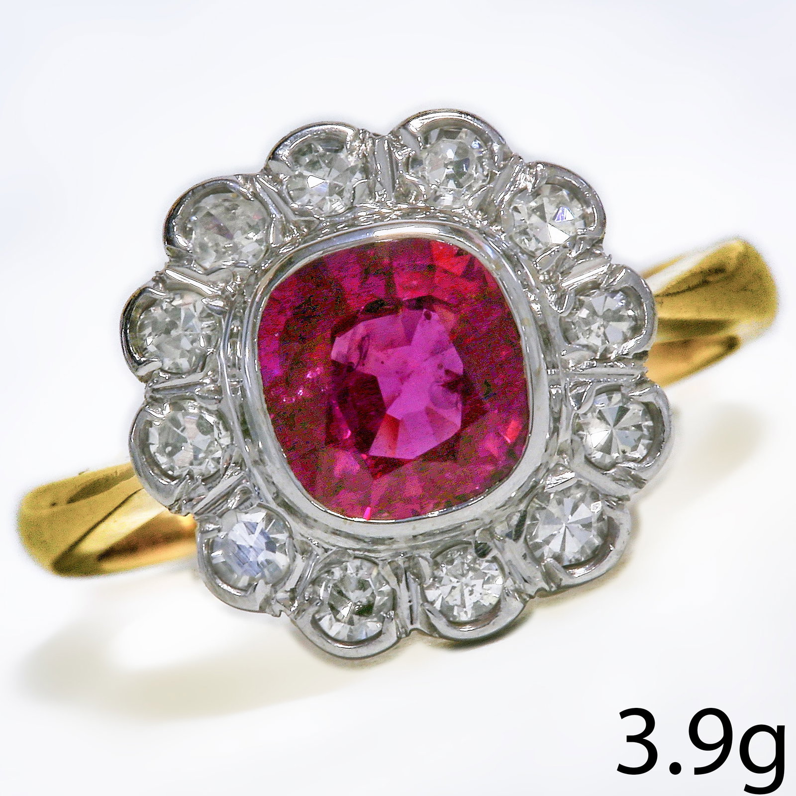 RUBY AND DIAMOND CLUSTER RING: RUBY AND DIAMOND CLUSTER RING 3.8 grams 18 ct vibrant ruby with no abrasions lively diamonds size F