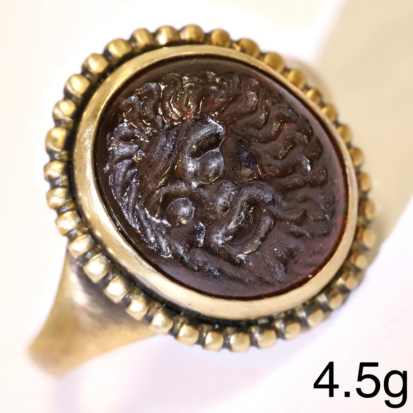 ANCIENT GARNET INTAGLIO 3RD CENTURY ROMAN SASSANIAN, RING: ANCIENT GARNET INTAGLIO 3RD CENTURY ROMAN SASSANIAN, RING.Detailed carved garnet intaglio depicting a bearded man.Later mounted into a ring.Size M.