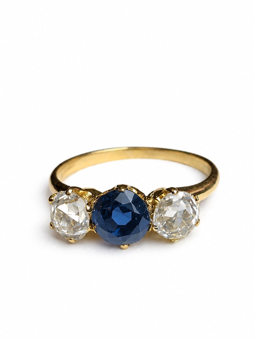 SAPPHIRE AND DIAMOND 3-STONE RING: SAPPHIRE AND DIAMOND 3-STONE RING,testing 18 ct. gold.Rich and vibrant sapphire.Diamonds bright and lively.Size L 1/2.