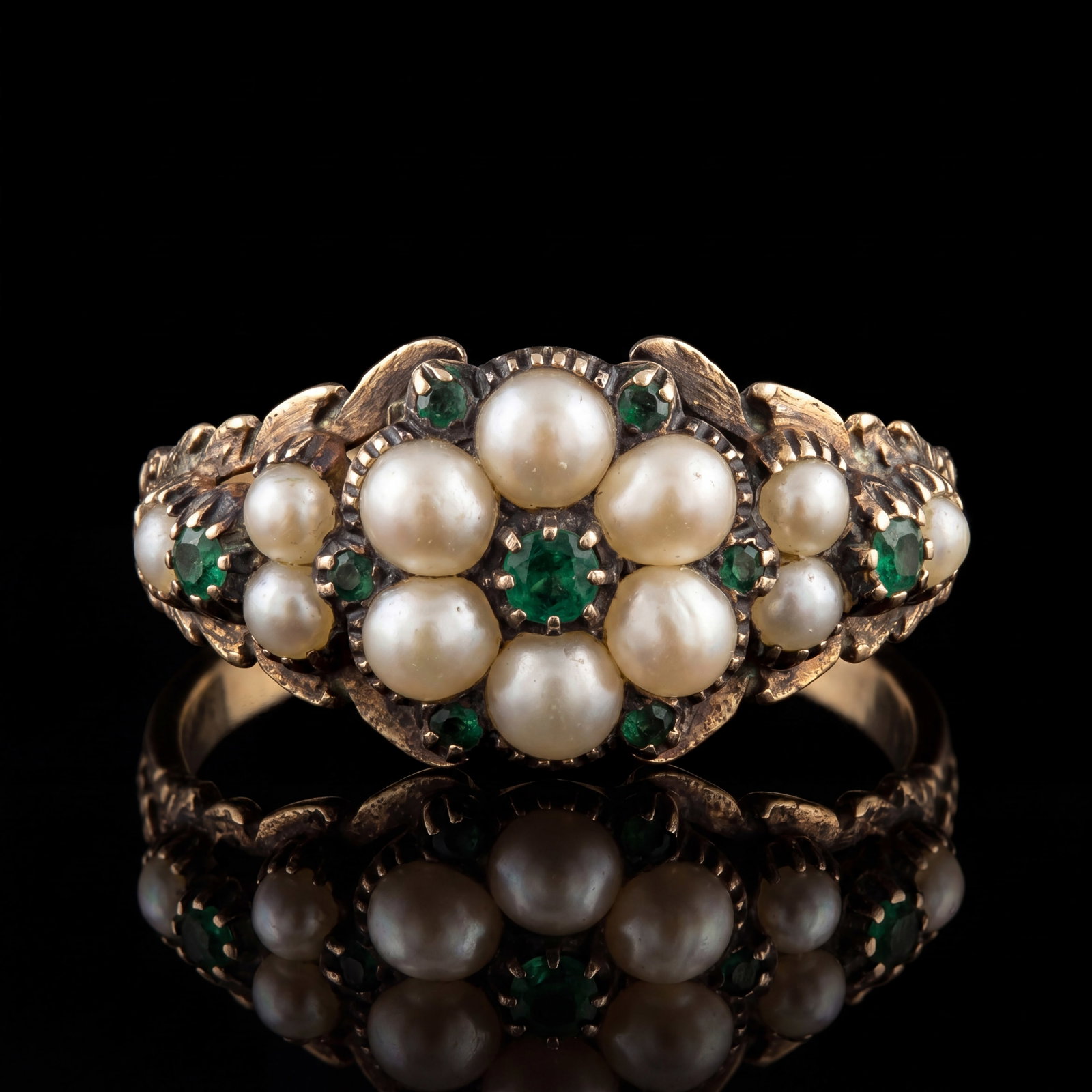 GEORGIAN EMERALD AND PEARL RING: GEORGIAN EMERALD AND PEARL RING,3,5 grams, testing high carat gold.Lovely emerald.Generally well matched pearls.Locket back.Size M.