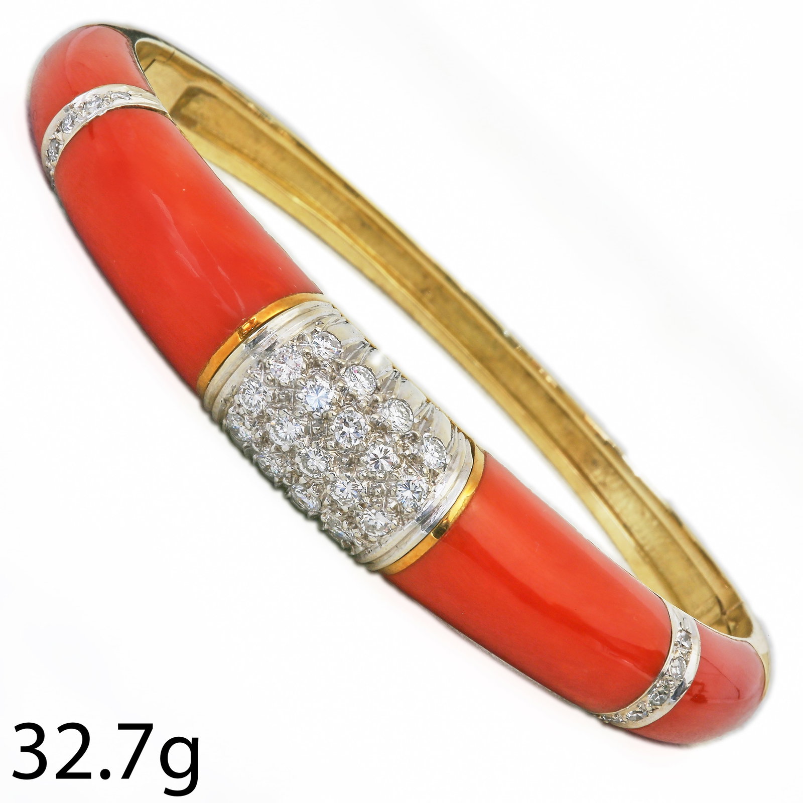 CORAL AND DIAMOND BANGLE: CORAL AND DIAMOND BANGLE,37.2 grams, 18 ct. gold.Diamonds bright and lively.Fine coral, well matched.Inner diam. 5.6 cm.